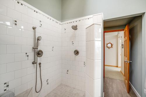 a bathroom with a shower with white tiles at Beautiful Birch Bay Retreat with Deck and Fire Pit! in Blaine