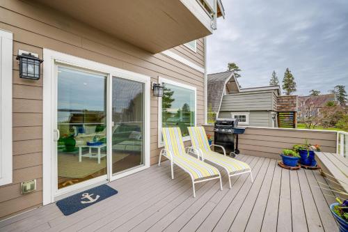 a deck with two chairs and a grill on a house at Beautiful Birch Bay Retreat with Deck and Fire Pit! in Blaine