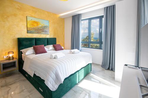 a bedroom with a large bed with towels on it at SunnySide luxury suites with free parking and swimming pool in Brela