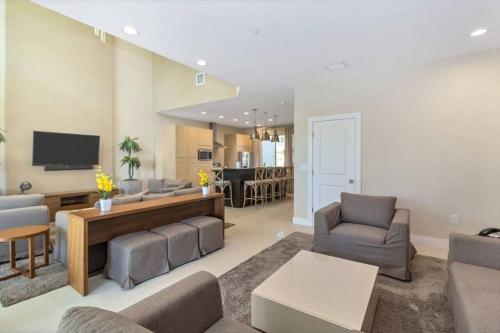 a living room with a couch and chairs and a tv at Magical Disney Home (45366427) in Orlando