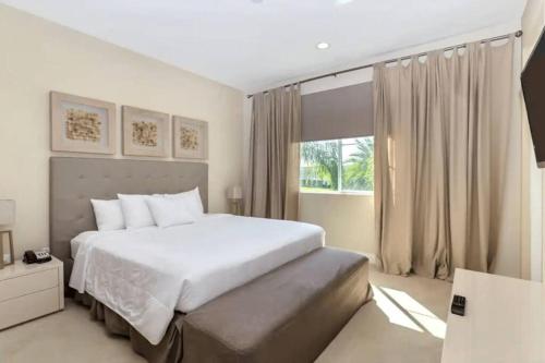 a bedroom with a white bed and a window at Magical Disney Home (45366427) in Orlando