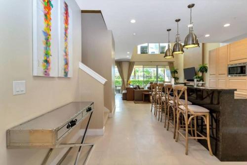 a kitchen with a bar with stools and a counter at Magical Disney Home (45366427) in Orlando
