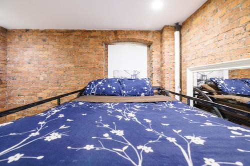 a bed in a room with a brick wall at Studios in New York in New York
