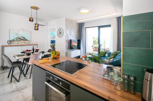 a kitchen and living room with a counter top at SunnySide luxury suites with free parking and swimming pool in Brela