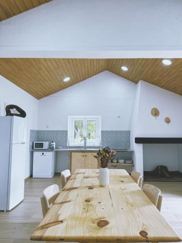 a large wooden table in a kitchen with a large table at Monte da Boavista in Alcácer do Sal