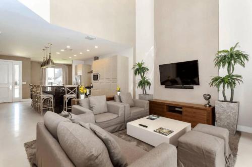 a living room with a couch and a table at Disney Dream Home (7662508) in Orlando