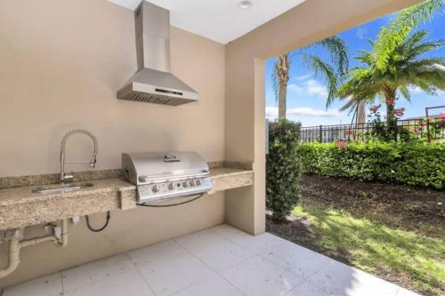 a kitchen with a sink and a stove at Disney Dream Home (7662508) in Orlando