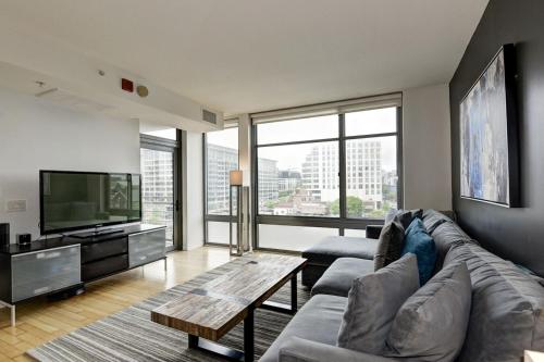 a living room with a couch and a television at Casa Catherine in Austin