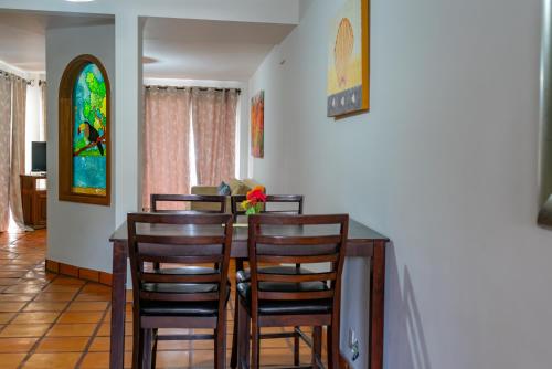 a dining room with a table with chairs and a stained glass window at La Concha Beach Hotel & Club in La Paz