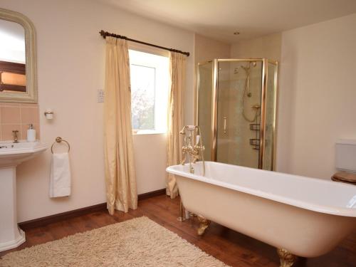 a bathroom with a tub and a shower at 5 bed in Barnstaple SHIRW in Shirwell