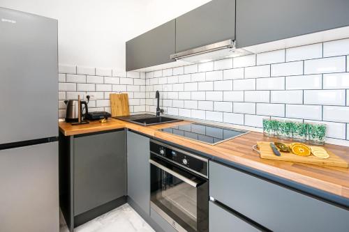 a kitchen with a sink and a counter top at SunnySide luxury suites with free parking and swimming pool in Brela