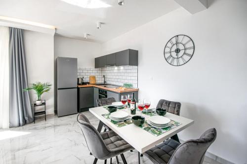 a kitchen and dining room with a table and chairs at SunnySide luxury suites with free parking and swimming pool in Brela