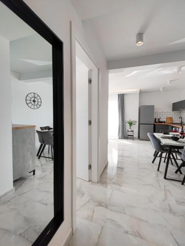 a living room with a mirror and a table at SunnySide luxury suites with free parking and swimming pool in Brela