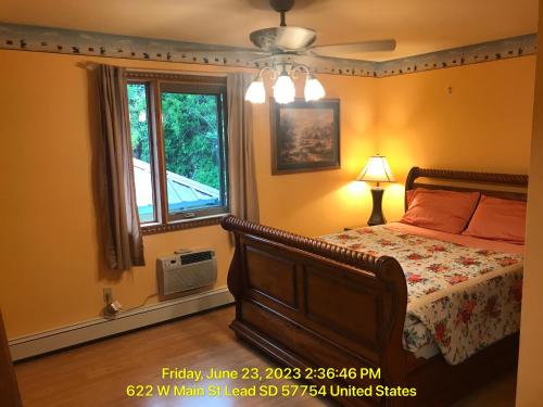 a bedroom with a bed and a window at West Main Lodge, 3 bedroom in Lead