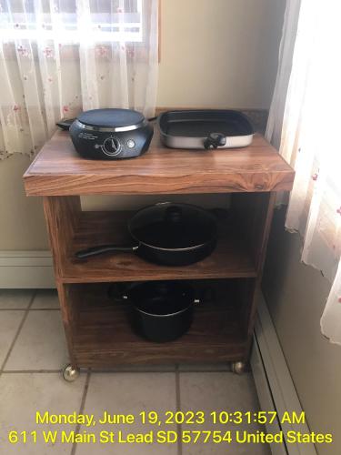 a table with a toaster and pans on it at West Main Lodge, 3 bedroom in Lead