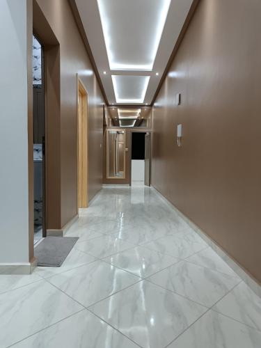 a hallway with white marble floors and a ceiling at Hotel apartment america in Dakhla