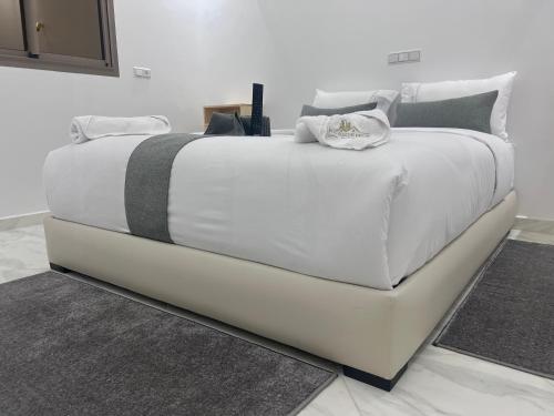 a large white bed in a white room at Hotel apartment america in Dakhla