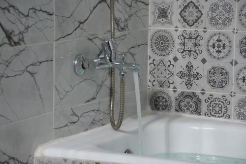 a shower in a bathroom with a white tub at Hotel apartment america in Dakhla