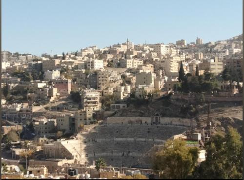 a view of a city with buildings on a hill at Al Amawi Hostel in Amman