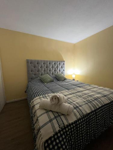 een slaapkamer met een bed met een handdoek erop bij Departamento equipado 322 Ovalle in Ovalle