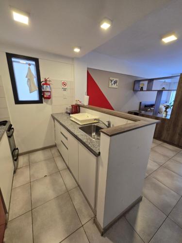 a kitchen with a sink and a counter top at Barrancas del Monumento con Parking privado opcional in Rosario
