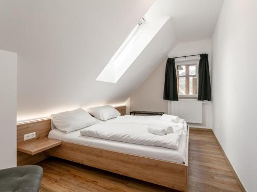 a bedroom with a bed with white sheets and a window at NRV Top 567 XL in Möderbrugg