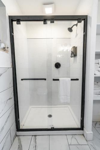 a shower with a glass door in a bathroom at Edgewater Lodge in Layton