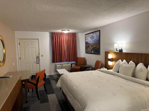 a hotel room with a bed and a desk at Abajo Lodge in Monticello
