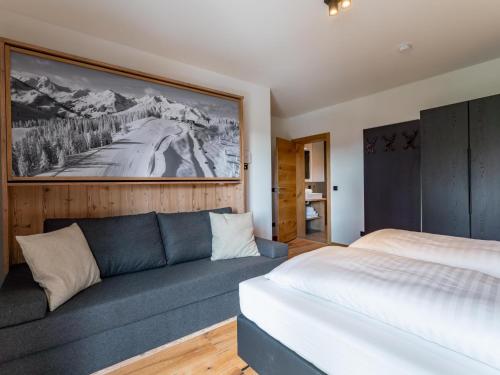 a bedroom with a couch and a bed in it at The Cosy Bear Lodge in Turracher Hohe
