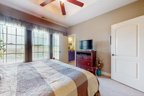 a bedroom with a bed and a flat screen tv at Relax a While in Hollister