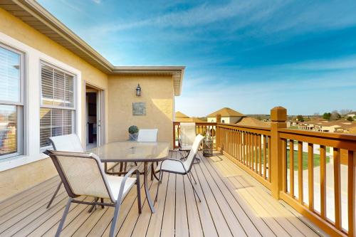 a wooden deck with a table and chairs on it at Relax a While in Hollister