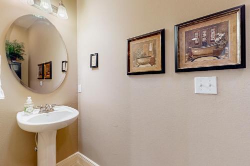 a bathroom with a sink and a mirror at Relax a While in Hollister
