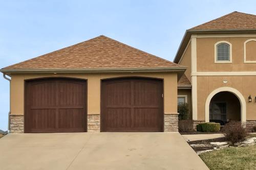 a house with two garage doors in a driveway at Relax a While in Hollister