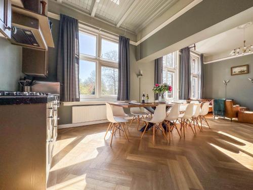 a kitchen and dining room with a table and chairs at Groot Weeshuis in Enkhuizen