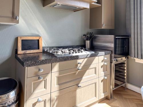 a kitchen with a sink and a stove in it at Groot Weeshuis in Enkhuizen