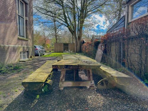 a wooden picnic table in front of a building at Groot Weeshuis in Enkhuizen