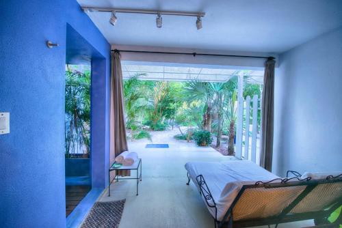 a bedroom with a bed and a large sliding glass door at Casa Morada in Islamorada