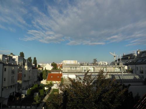 a view of a city with buildings and a blue sky at Hotel Donaustadt Kagran - at Metro U1 in Vienna
