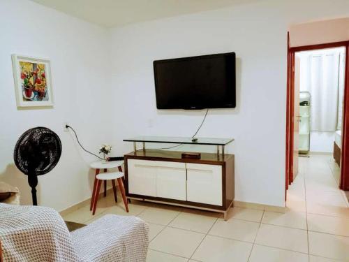 a living room with a flat screen tv on a wall at Samambaia QI 616 in Brasilia