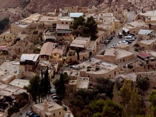 an aerial view of a small town with buildings and cars at Dana Gardens Hotel in Dana
