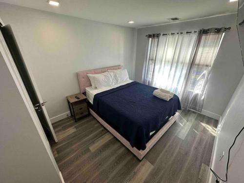 a bedroom with a bed and a wooden floor at The Classic Suite: 2BR close to NYC in Paterson