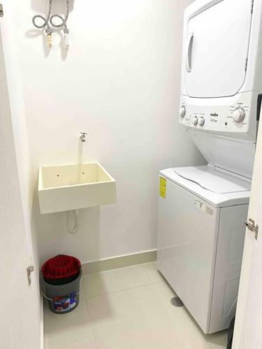 a small bathroom with a sink and a washing machine at New apartment Neen in Cancún