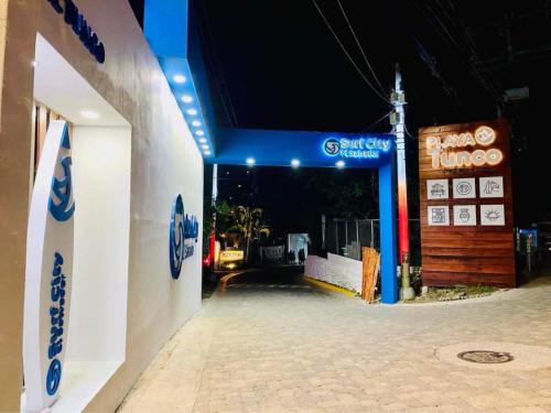 a gas station with a blue sign on the side of it at Hostal Camila’s in Tamanique