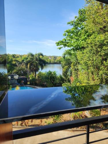 a view of a river from the balcony of a house at Riverduplex - Luxury duplex at a fair price in Dauis