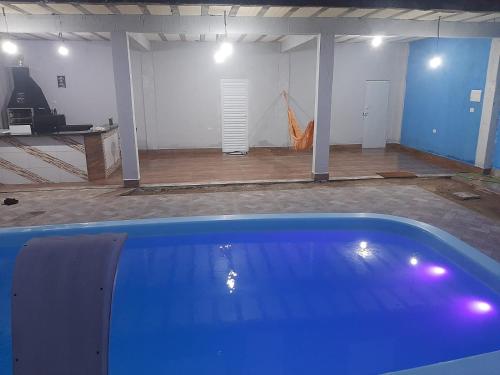 een garage met een zwembad in het midden van een kamer bij Recanto caçapava in Caçapava