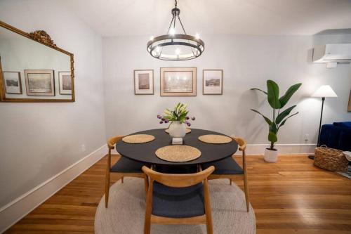 a dining room with a black table and chairs at Apt in the heart of Main Street in Stroudsburg