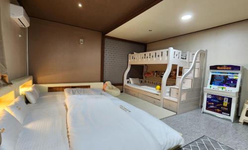 a bedroom with a bunk bed and a play room at Kids & Family Hotel in Gyeongju