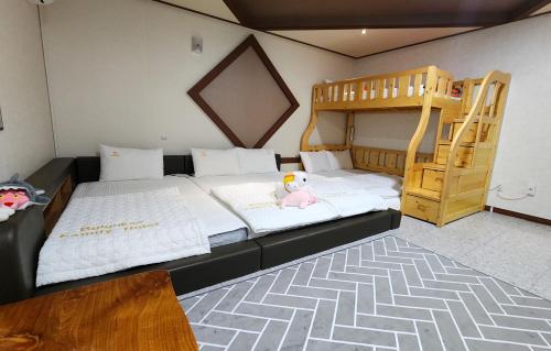 a bedroom with a bunk bed and a bunk ladder at Kids & Family Hotel in Gyeongju