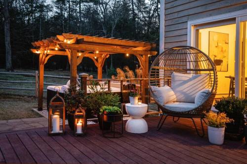 a porch with a gazebo and a chair and a swing at Woodstock Retreat- Heated Pool/Hot Tub/FirePit in Saugerties