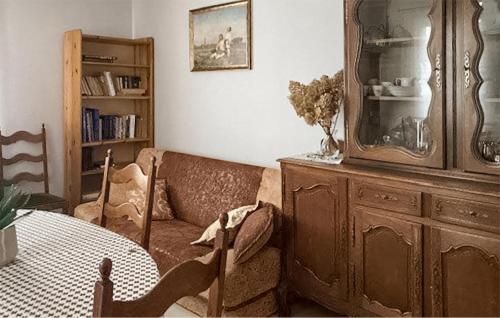 a living room with a couch and a table at Amazing Home In Trynisze Moszewo in Ciechanowiec